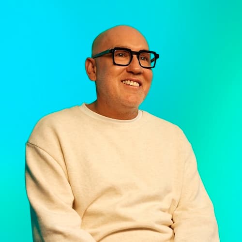 James, a man with glasses smiling