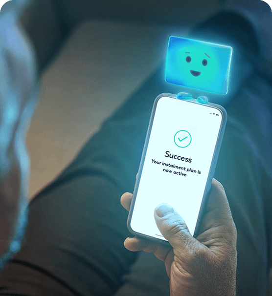 A man looking at the Aqua app on his phone to manage his instalment payments