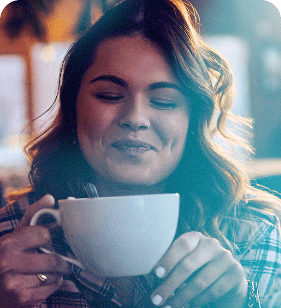 A woman enjoying a cup of coffee