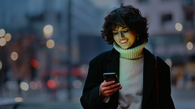 Person smiling at phone